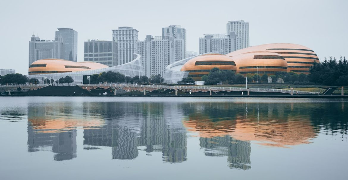 white and brown building near body of water during daytime